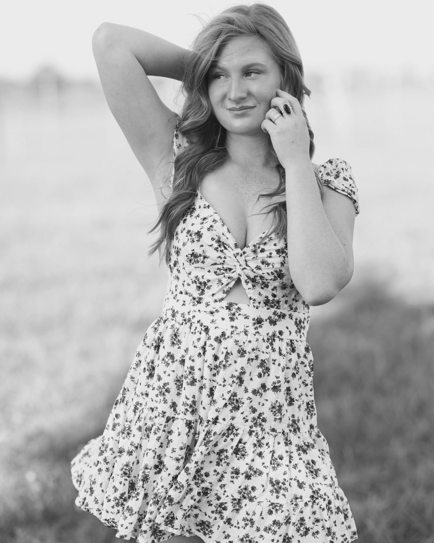 A series of black and white photos showing tender moments between a mother and child in a floral dress outdoors.