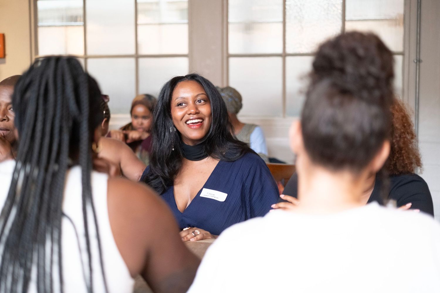 A group women gathered in conversation to shareful moment during a FundHership meeting.