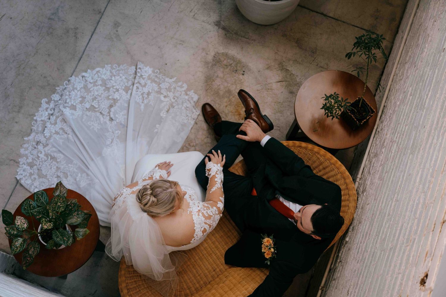 A bride and groom sharing a private moment before their ceremony. Shot from above as a candid photo.