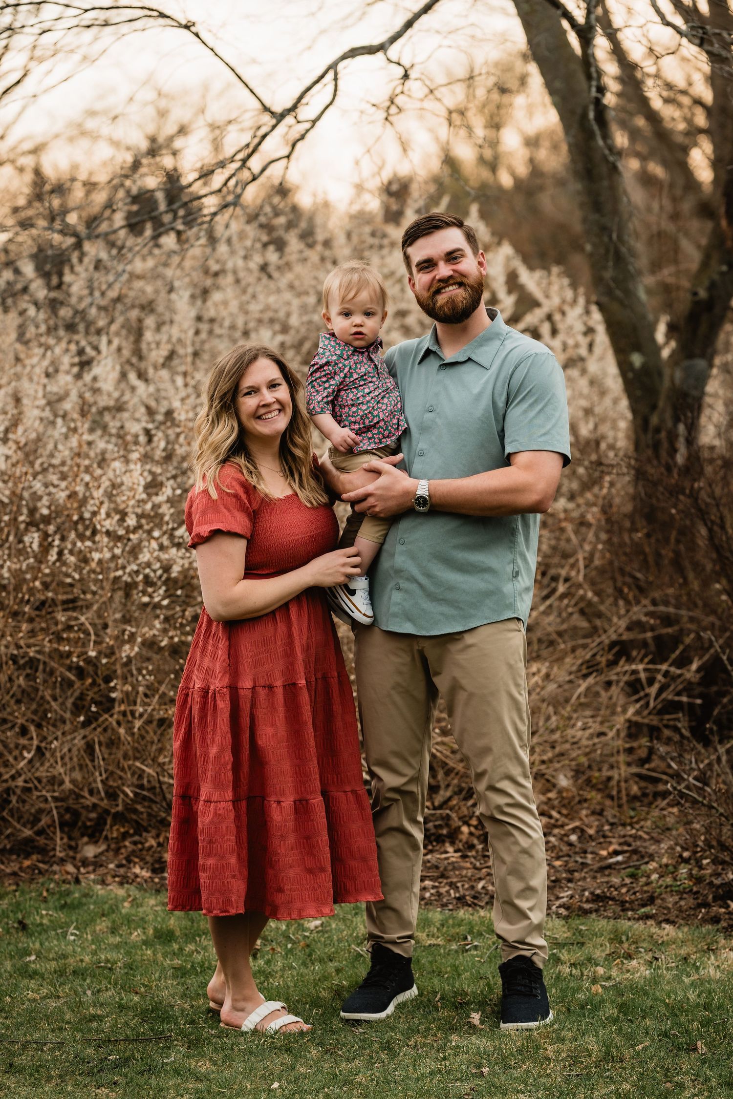 Amber + MJ hold their 1 year old.