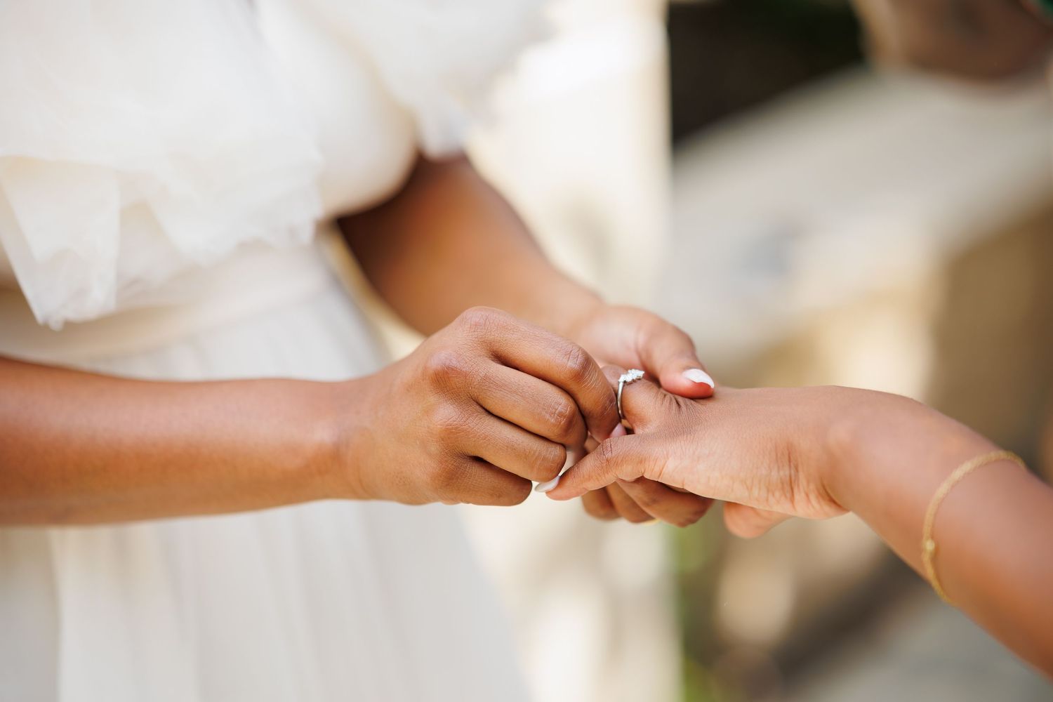 Two black women exchange rings during their intimate elopement at Dallas Arboretum