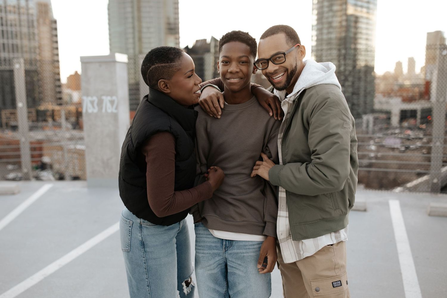 Group enjoying candid moments together on a city rooftop during golden hour.