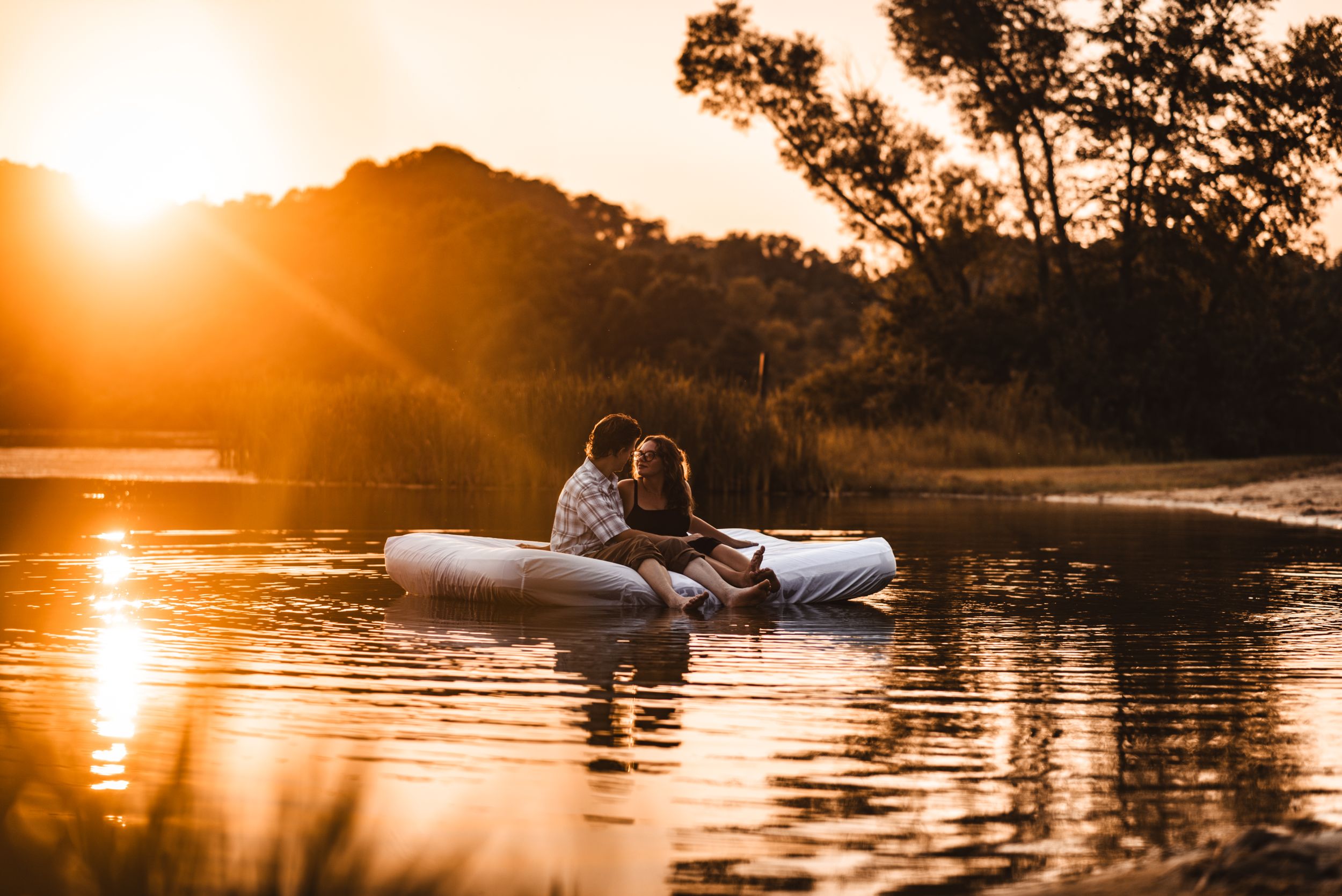A romantic sunset boat ride on calm waters with golden light reflecting off the surface.