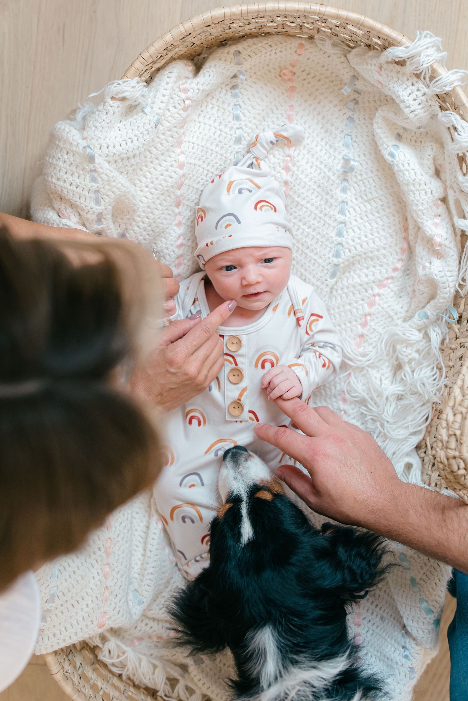 Baby wearing a simple neutral knot gown during a timeless newborn studio photo session in New Jersey.