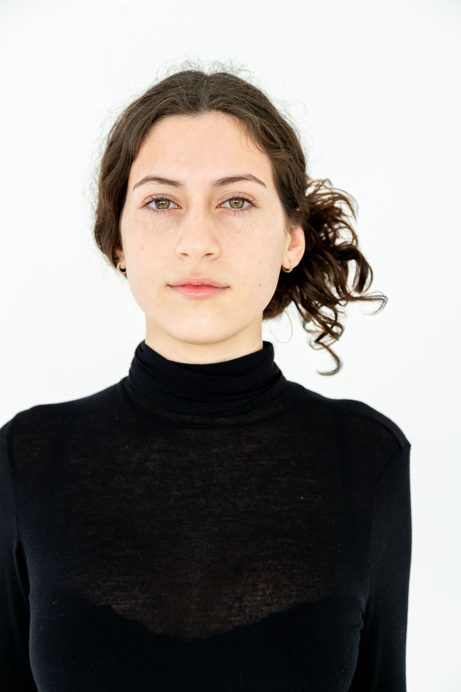 Portrait of someone wearing a black turtleneck sweater against a white background.