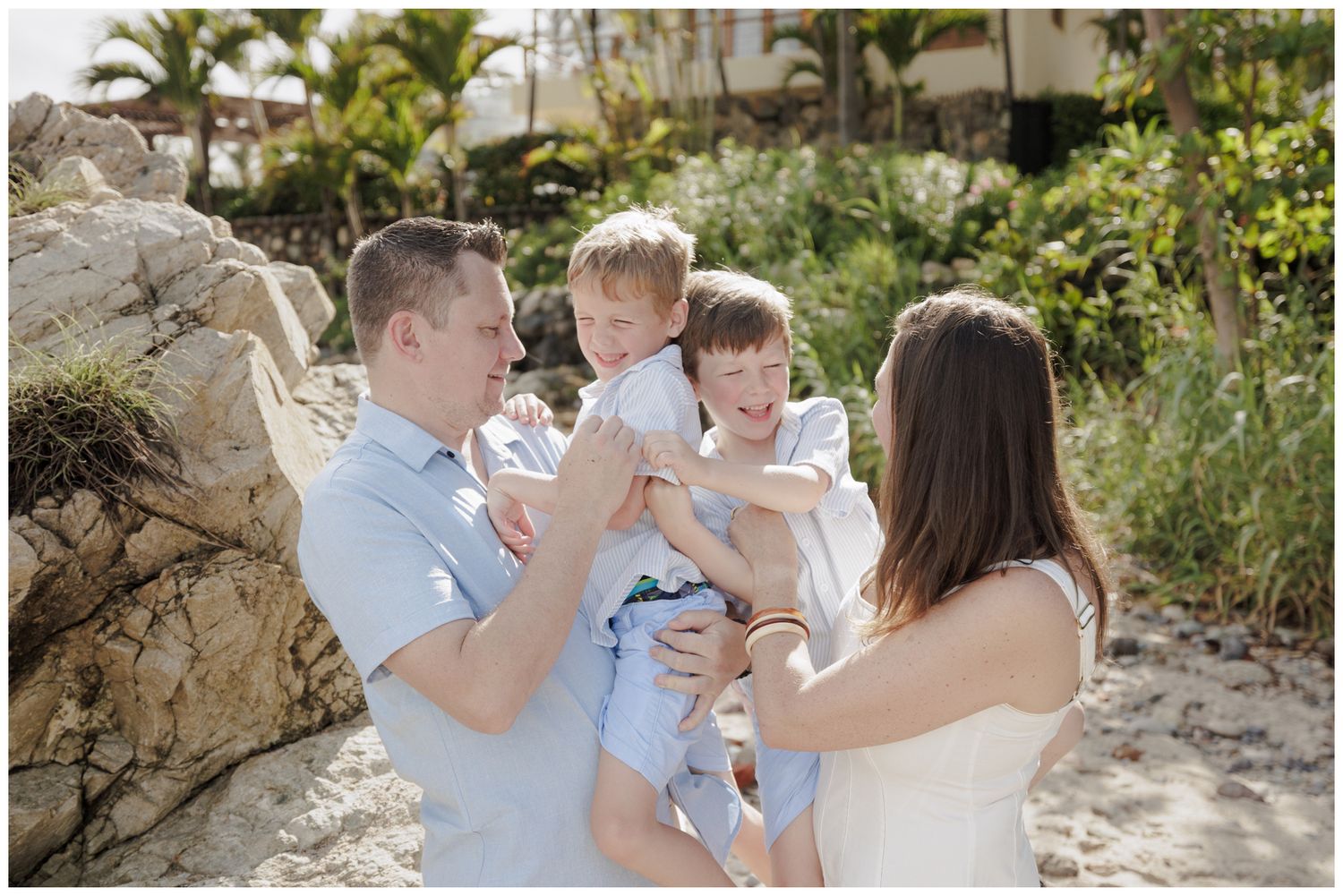 Family beach photos at Conchas Chinas Beach in Puerto Vallarta with parents and their two sons.