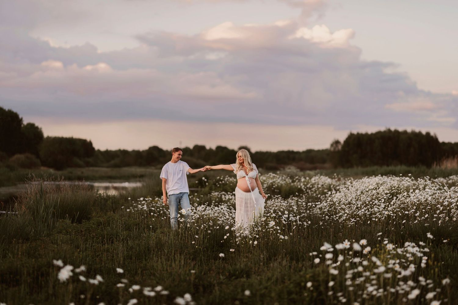 Five sequential photos show people dancing together in a sunset meadow filled with white wildflowers on a cloudy evening.