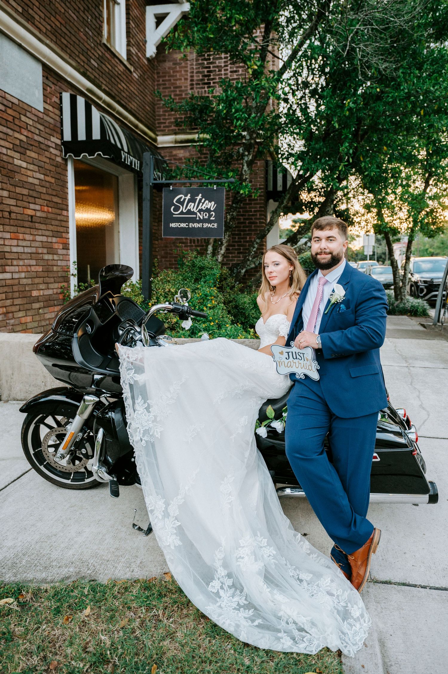 A sequence of wedding photos showing a couple posing playfully near a brick building with a motorcycle.