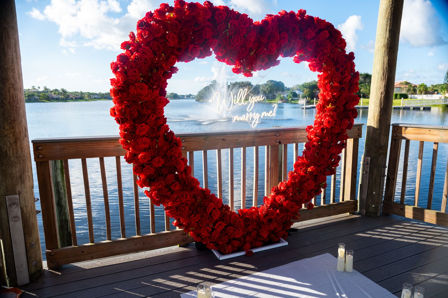 Elegant proposal decor with a heart filled with roses and candles all around, with Will you marry me, by proposal photographers in Florida