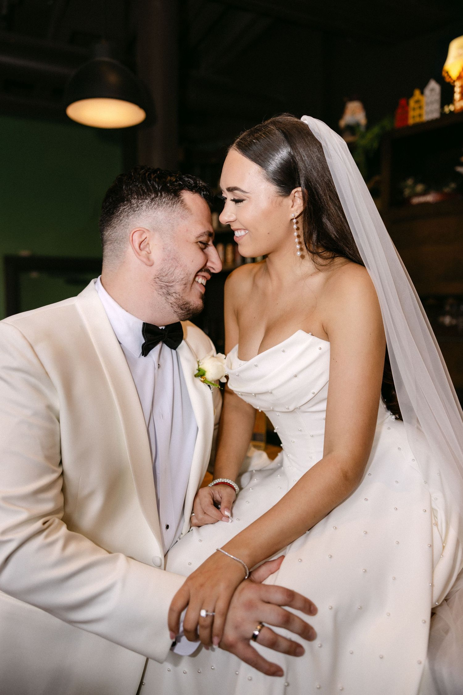 A romantic wedding sequence showing tender moments between newlyweds in white attire during their reception.