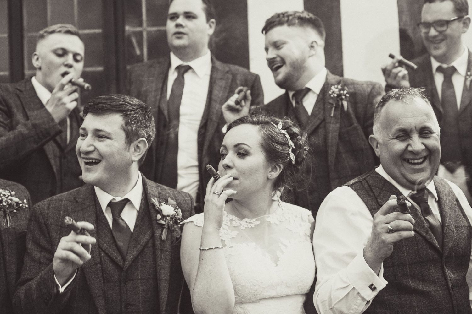 Family and friends enjoying a celebration cigar at weddinig reception.Why 10 Hours of Wedding Day Coverage Is Invaluable