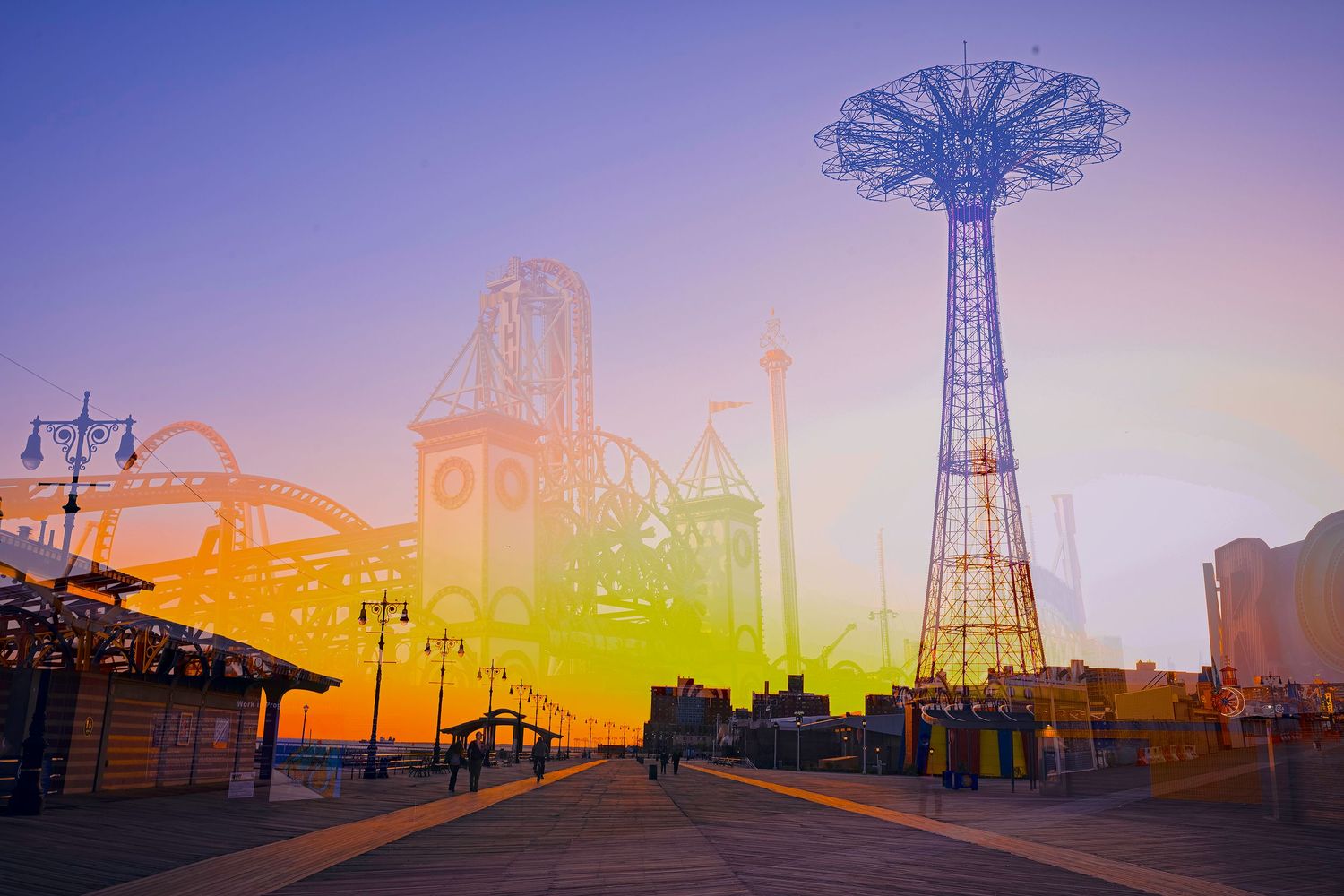 Iconic Coney Island amusement park silhouette against purple and yellow sunset sky.