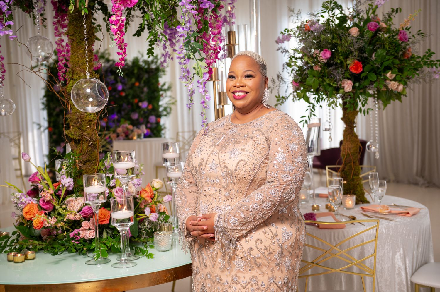 Atosha Barboza Bennett poses in front of one of her beautiful luxury designs photographed by Destination wedding photographers.