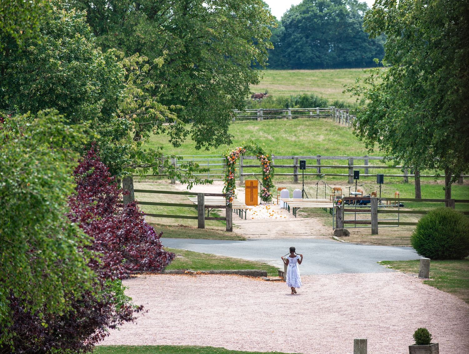 A little girl walking to the ceremony area in Clermont-Ferrand, France, was captured by Florida Destination wedding photographers.