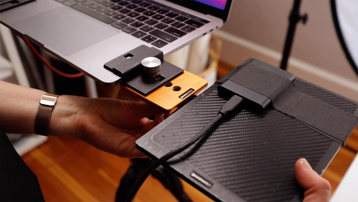 Laptop connected to external hard drives used for photo backup and storage.