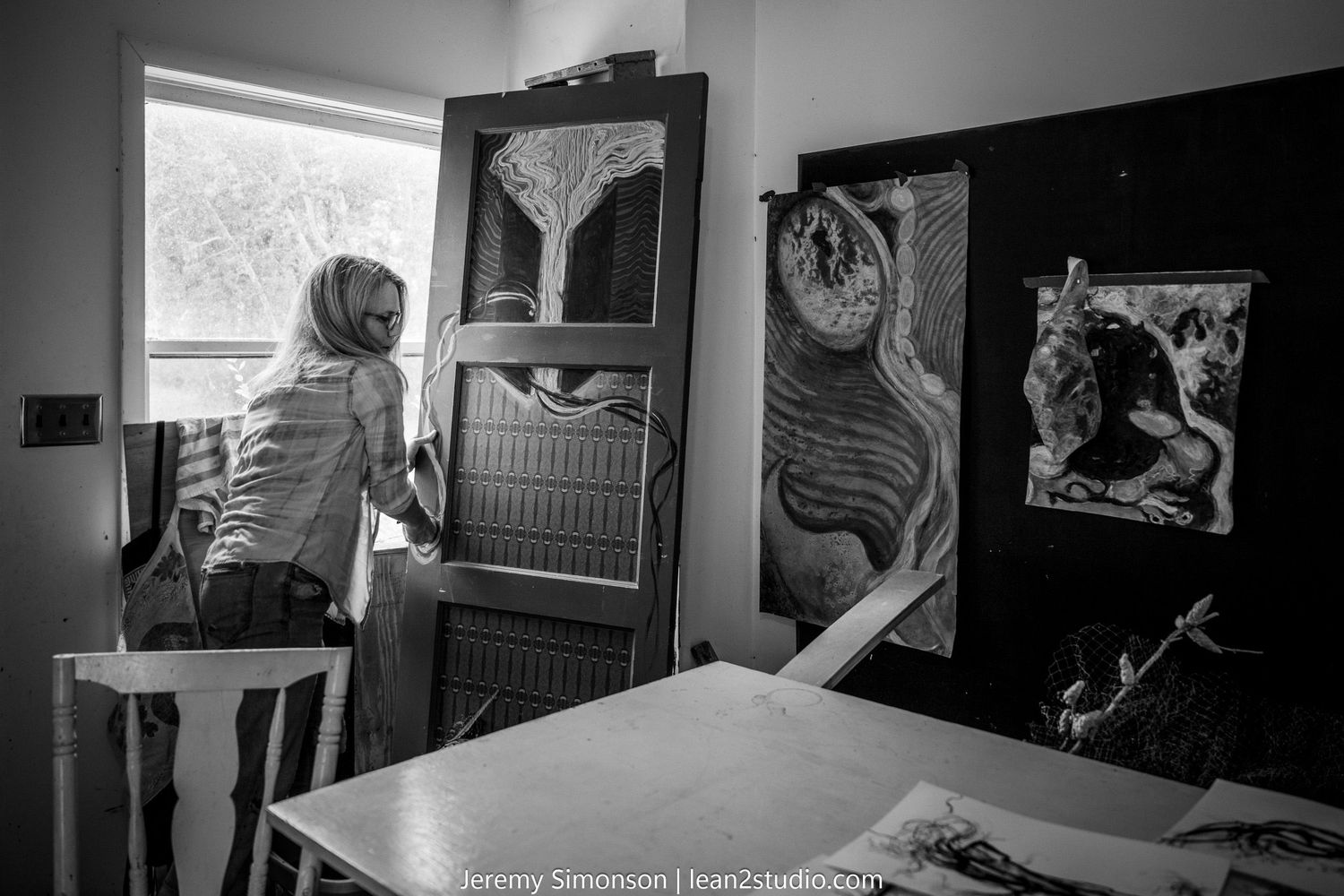 Black and white photographs show a cluttered workshop space with tools and equipment scattered throughout.