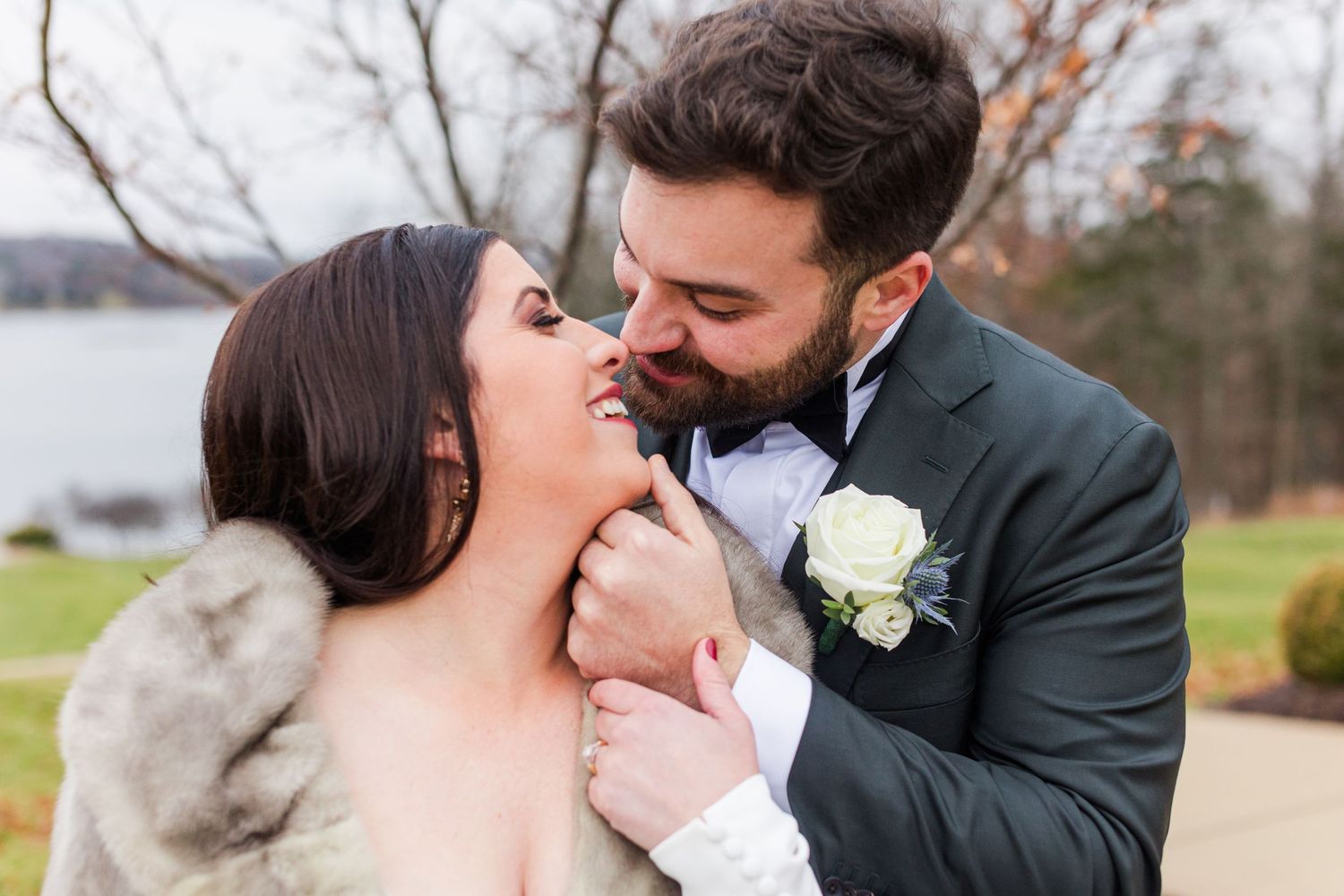 Newlyweds sharing an intimate moment outdoors in winter wedding attire. Innsbrook, Missouri microwedding.