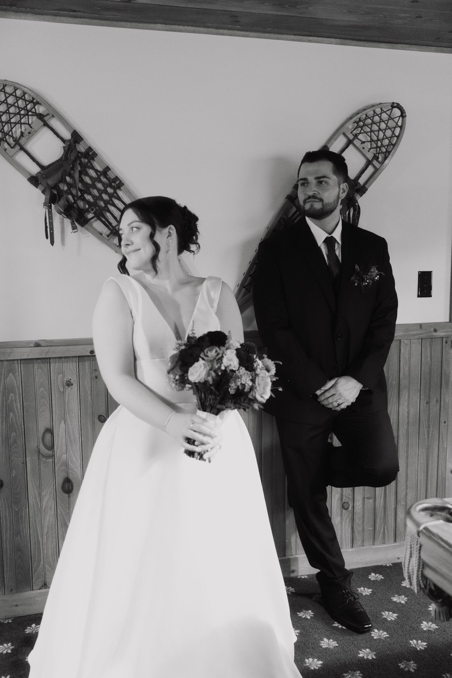 A series of black and white wedding photos showing tender moments between a couple in formal attire.
