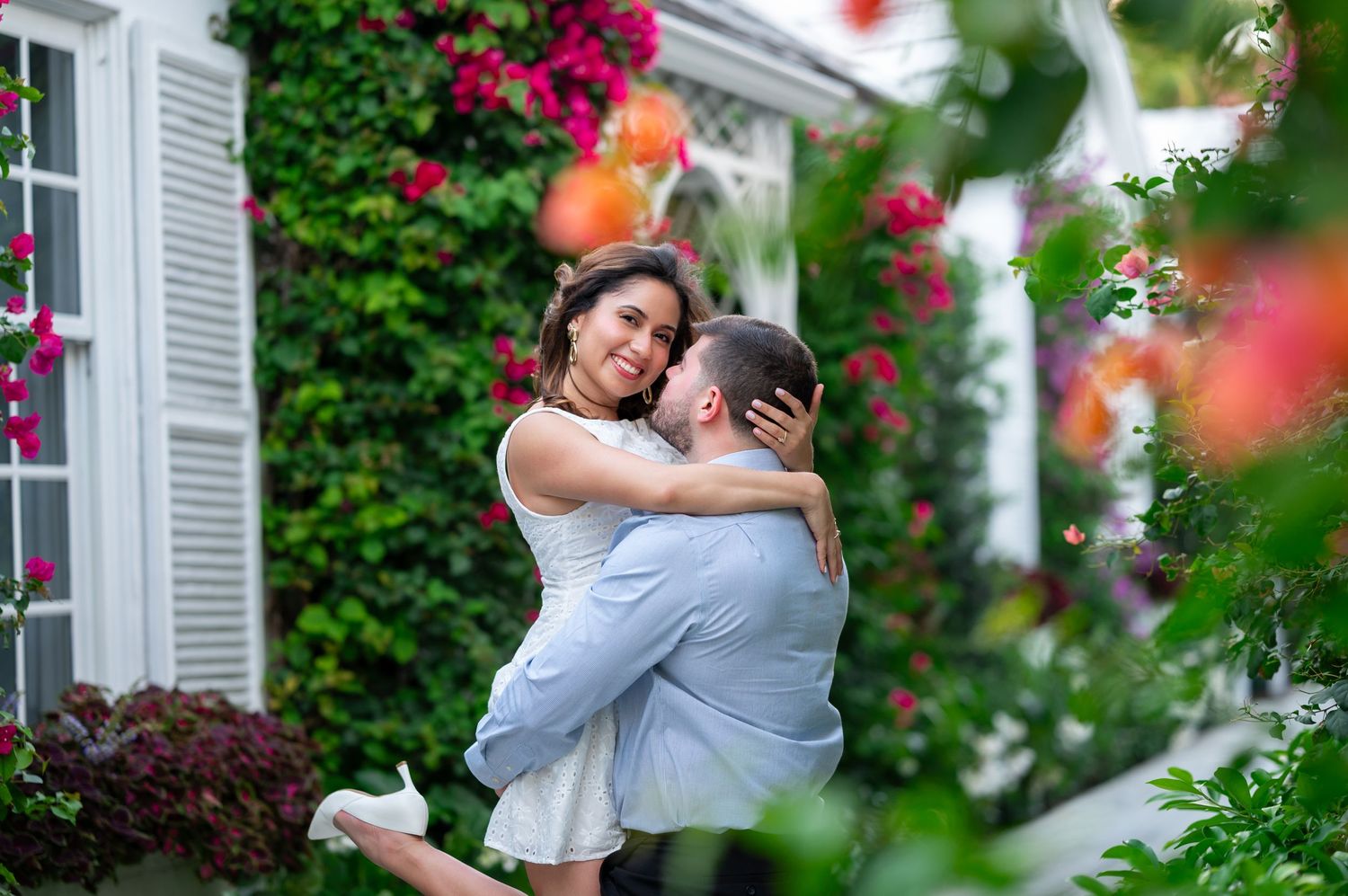 Angel holds Rocio, his fiancée, near the colorful flowers at Major Alley on Peruvian Avenue in Palm Beach, Florida.