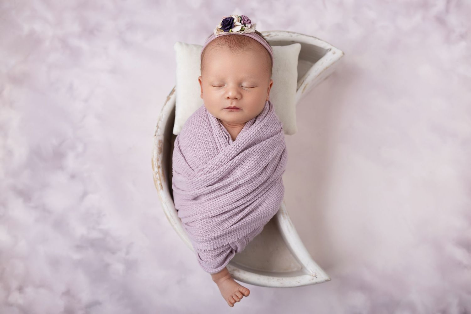 Eight connected professional newborn photography poses captured in light purple tones on a textured gray backdrop.