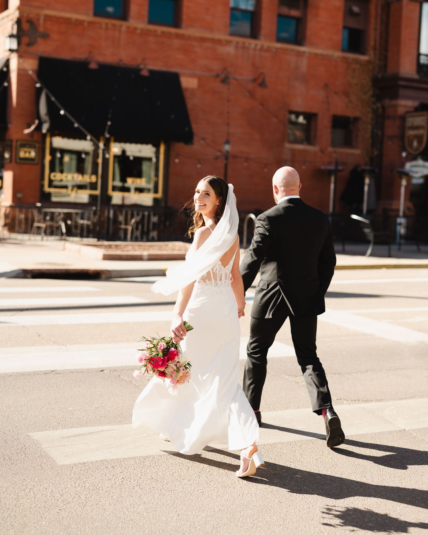 A couple shares intimate moments in a rustic wooden lodge with snowy mountain views.