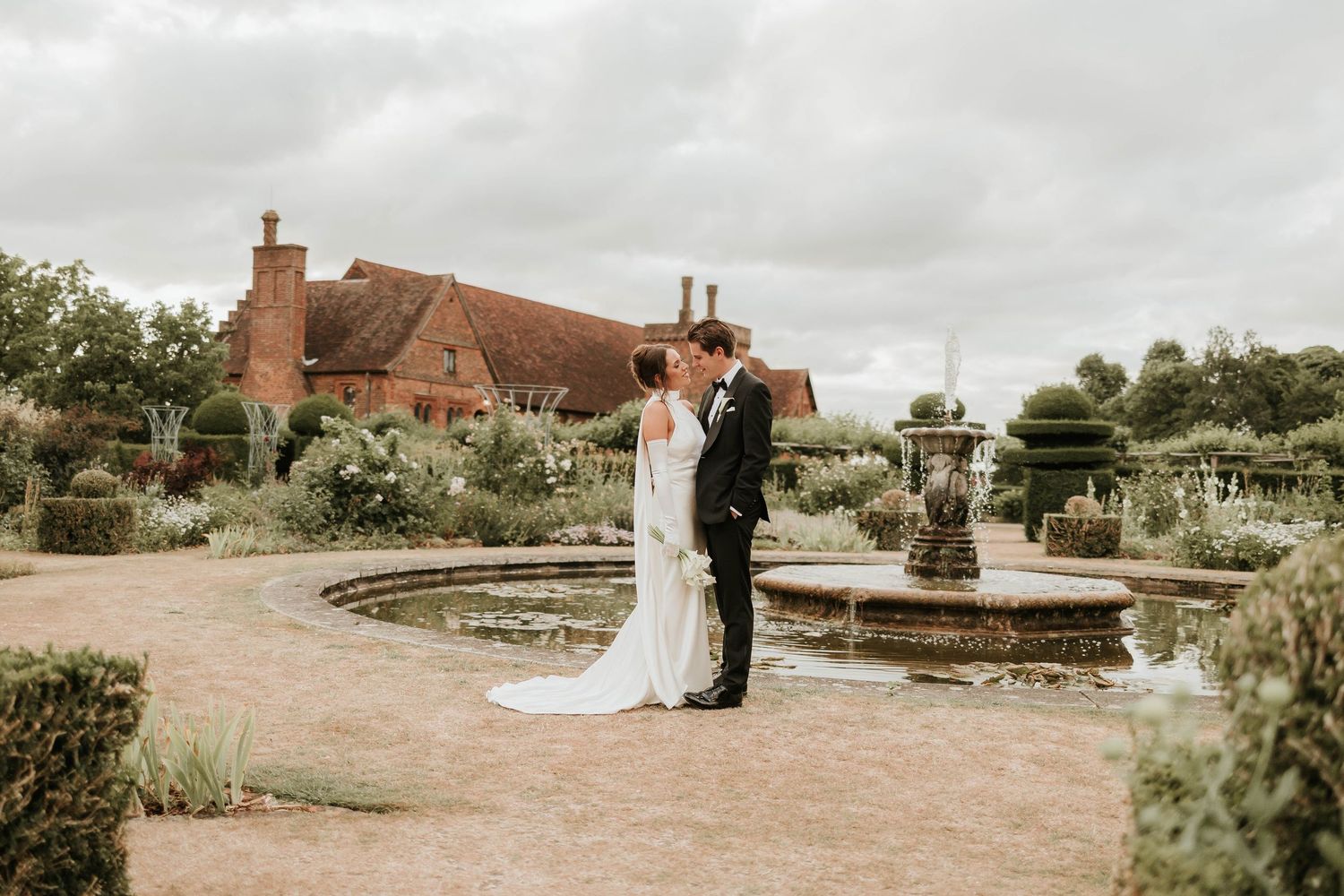Elegant stone manor house wedding venue with manicured lawns and classic Georgian architectural details.