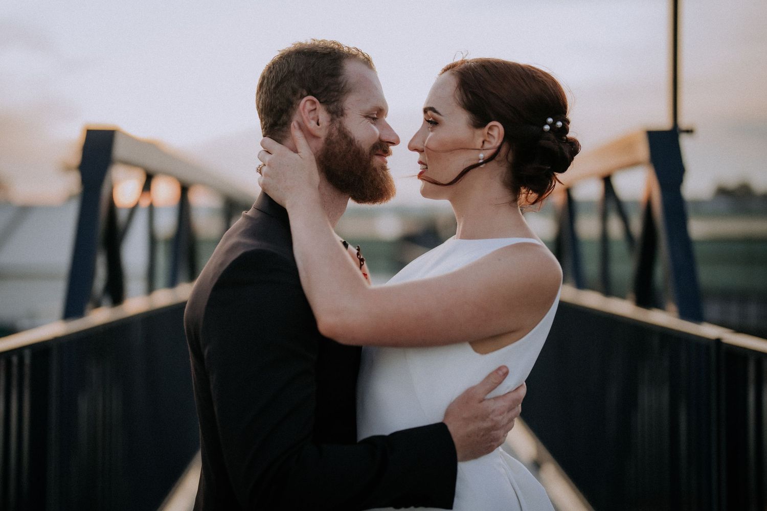 A romantic couple shares intimate moments in a series of wedding photos at sunset.