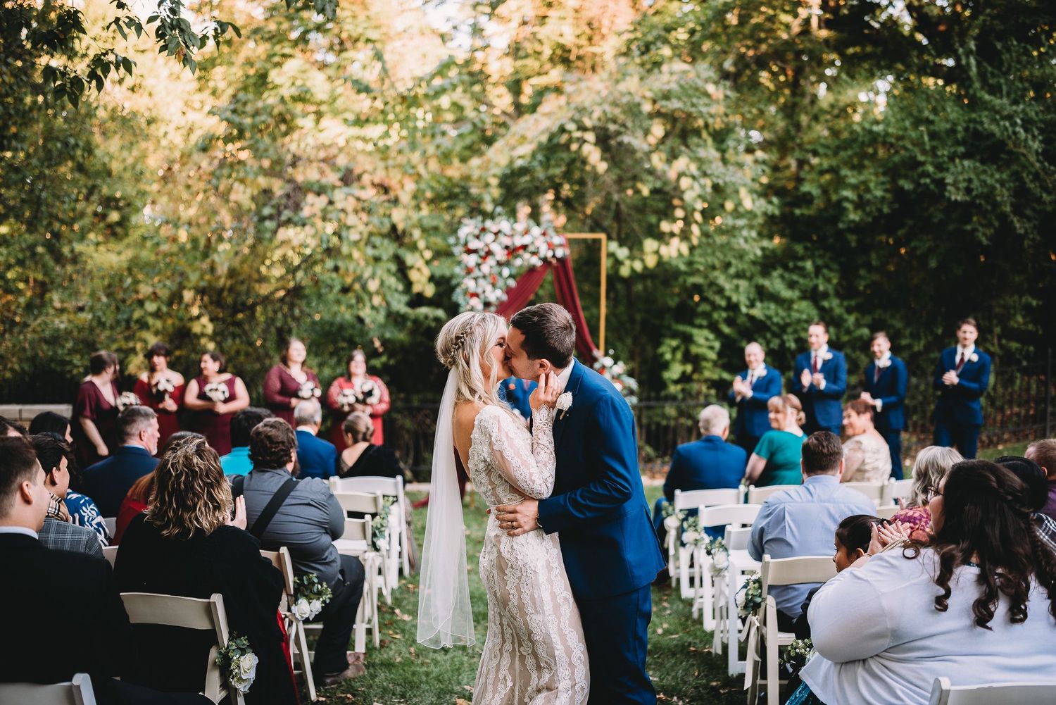 Bride and groom sharing a kiss at their wedding ceremony at Laurel Hall in Indianapolis