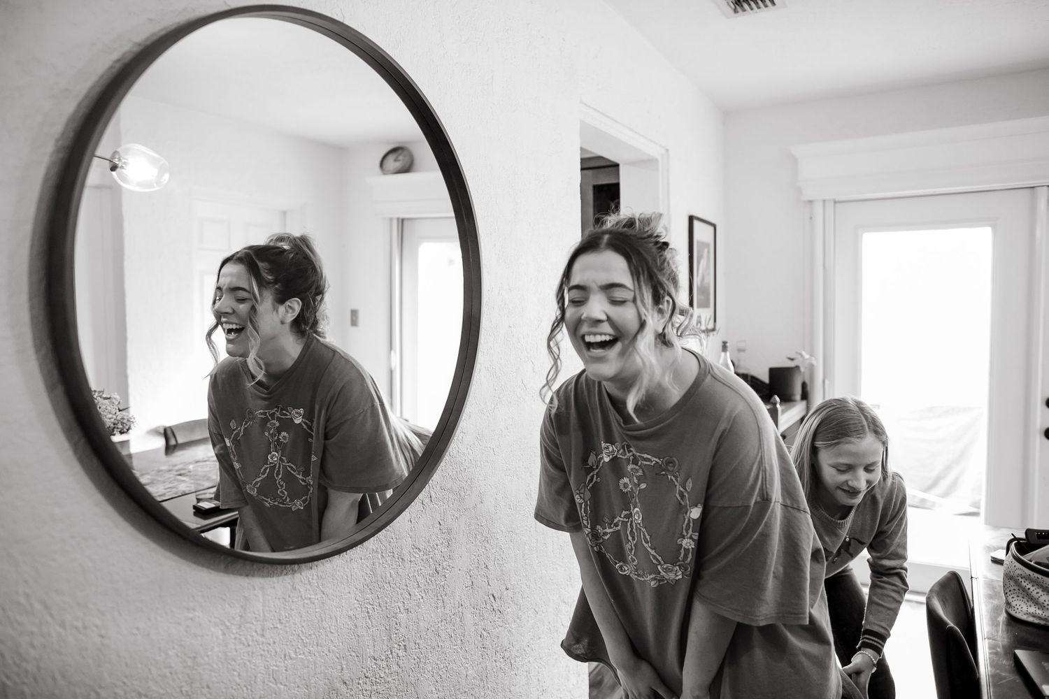 Black and white reflection shots in circular mirrors showing casual home moments.