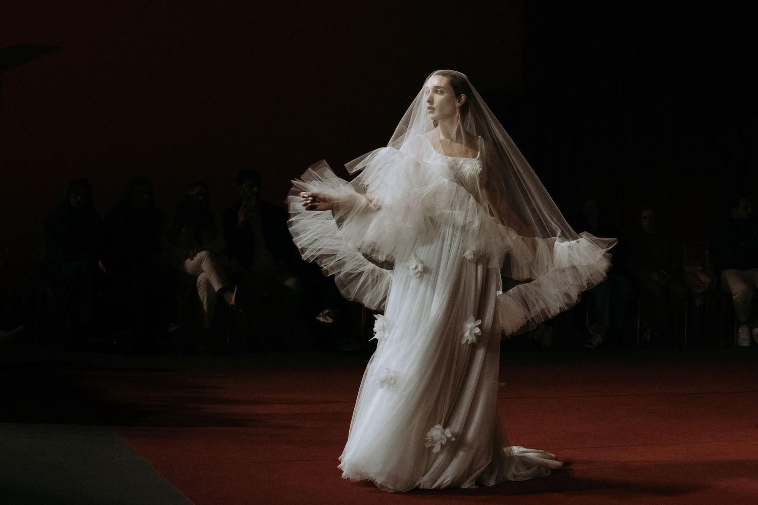 Illuminated garden wall creates an enchanting nighttime wedding atmosphere.