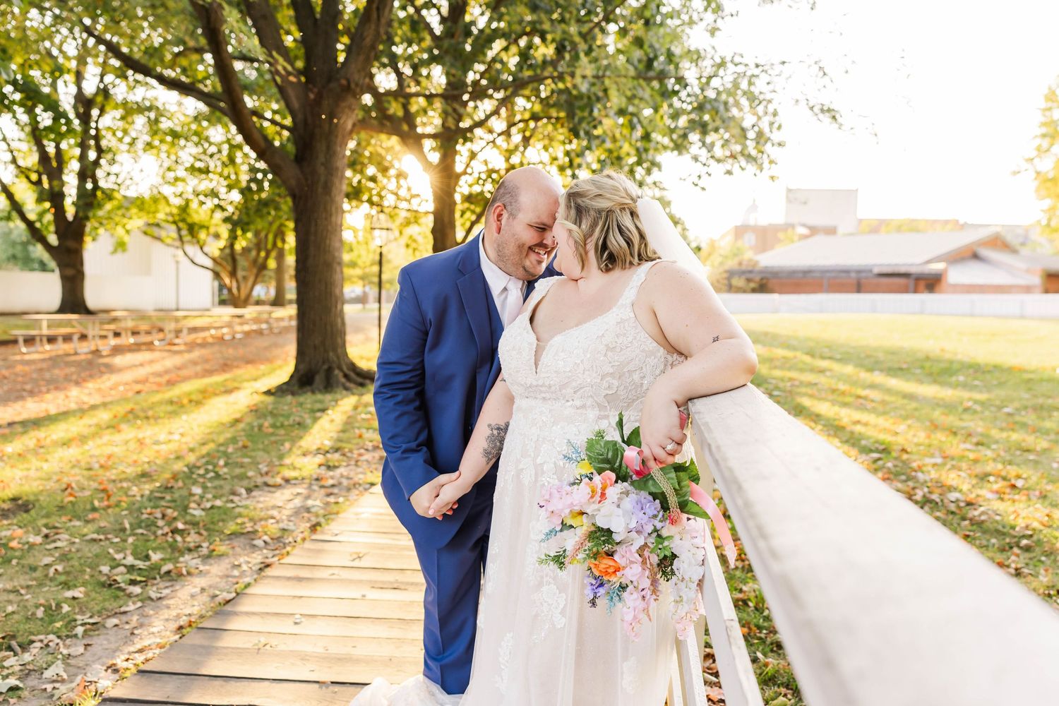 bride and groom touching foreheads during golden hour portraits at new salem springfield IL wedding photographer