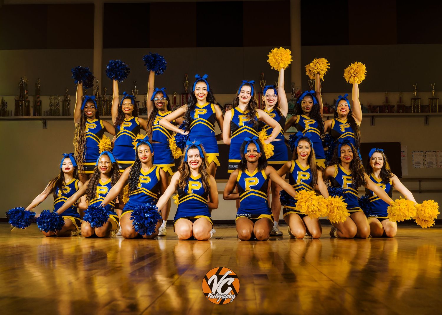 Pflugerville cheer team group photo with synchronized poses and cinematic lighting