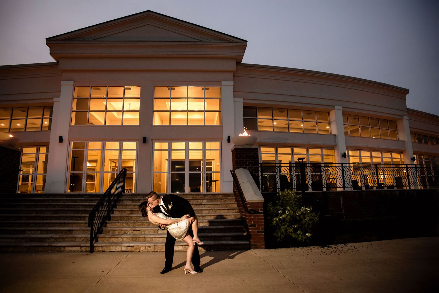 Nighttime photography of the wedding couple sharing a kiss at Waypoint 4180 in Canfield, Ohio