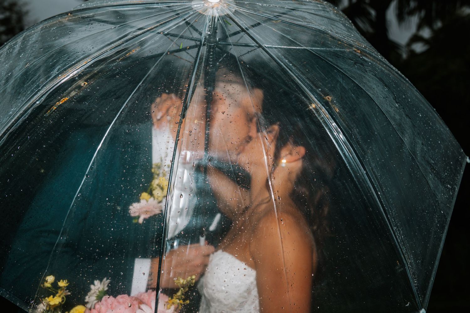 Six close-up shots show translucent umbrellas glowing softly while raindrops fall around them.