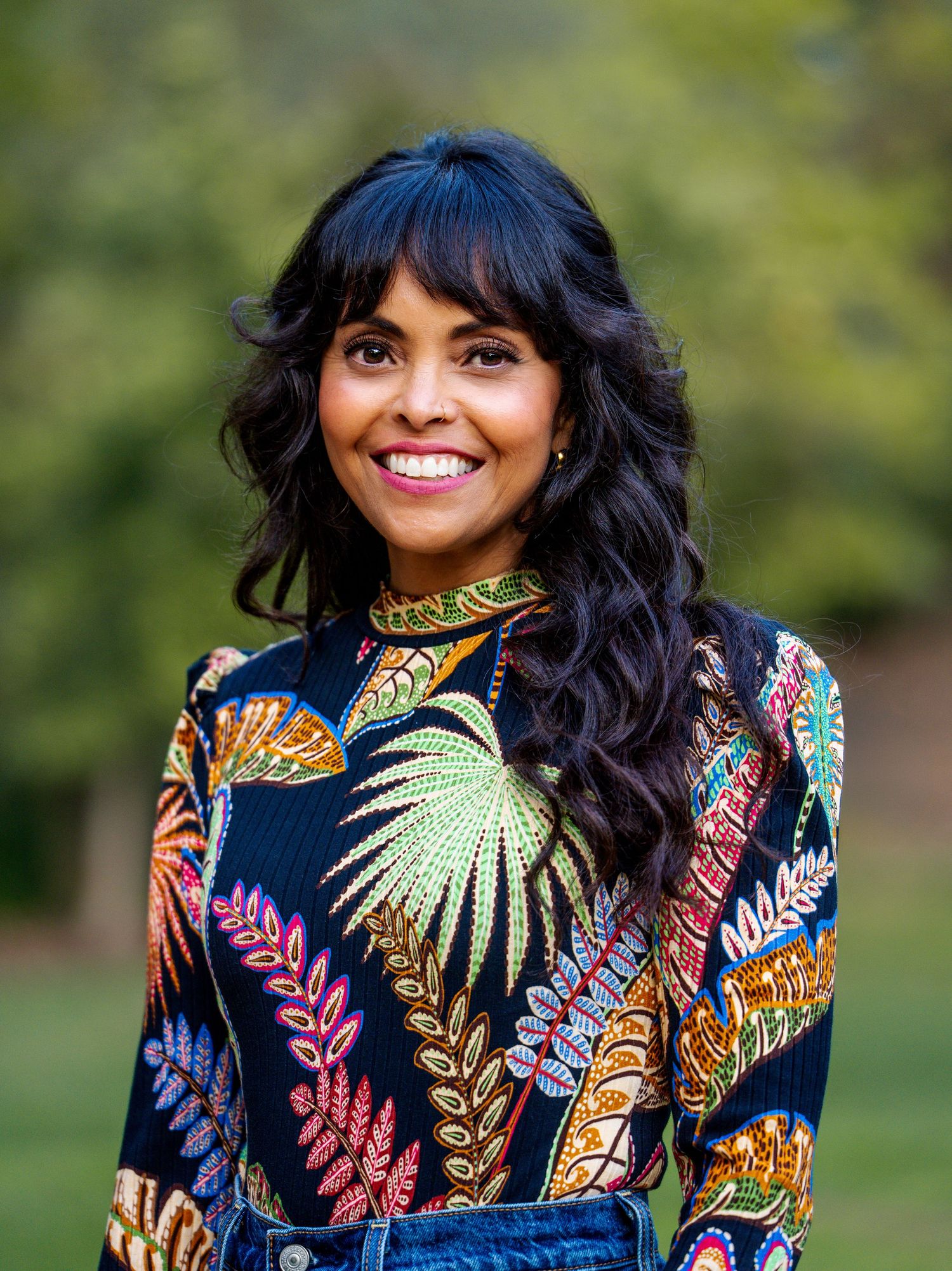 Woman wearing a colorful floral dress during an outdoor portrait session