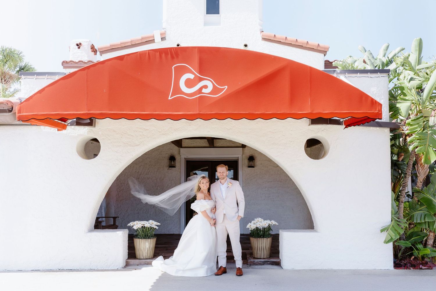 A collage of romantic wedding couple photos featuring outdoor archways and orange umbrellas creating a dreamy atmosphere.