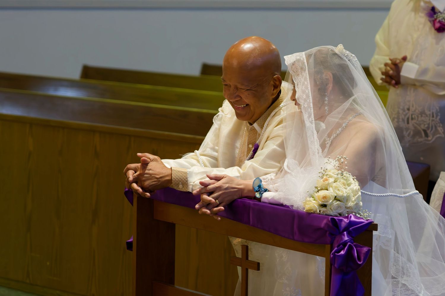 A romantic wedding moment with a couple embracing during their first dance in an elegant white reception venue.