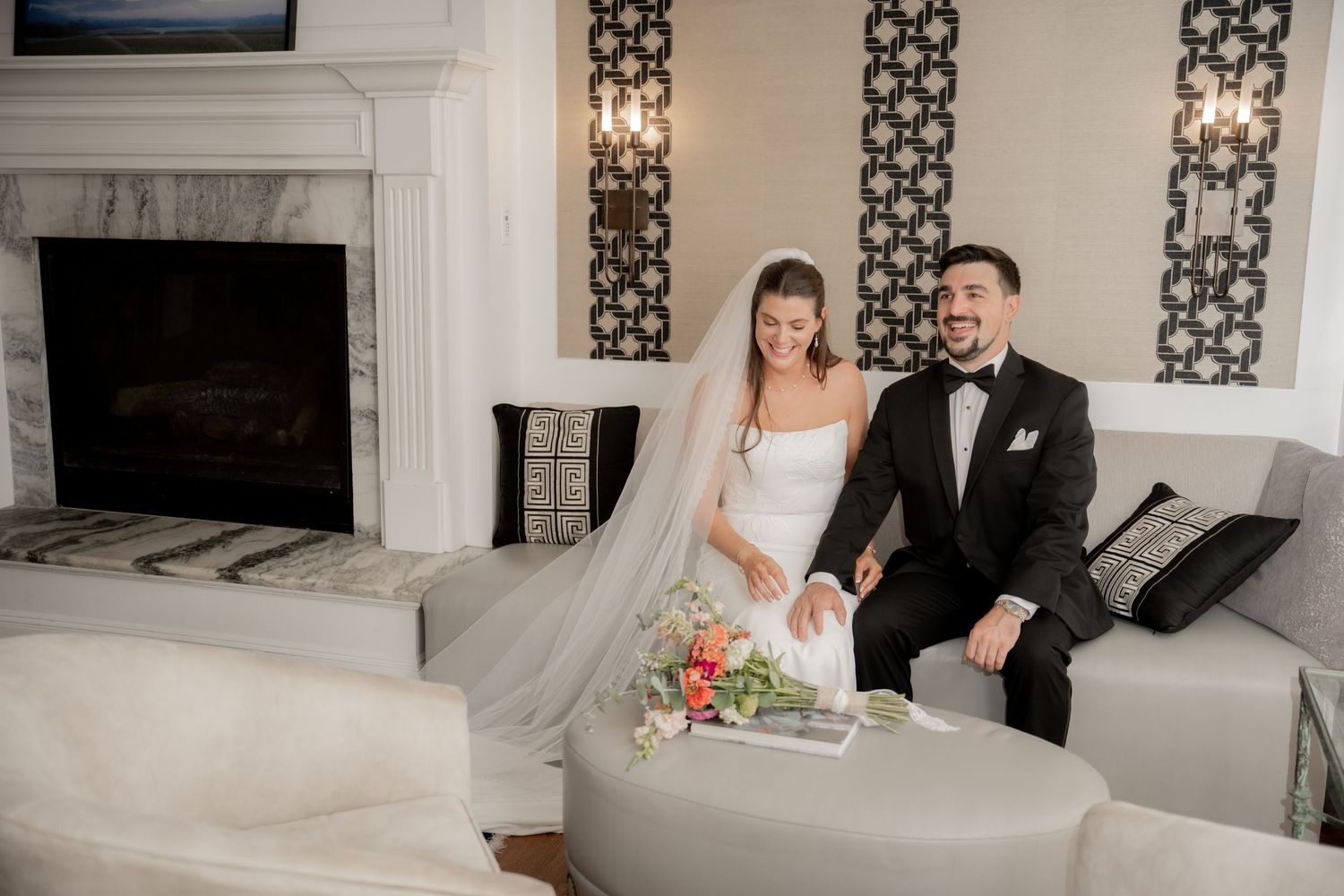 A black and white outdoor wedding ceremony scene among snow-covered grounds and pine trees.