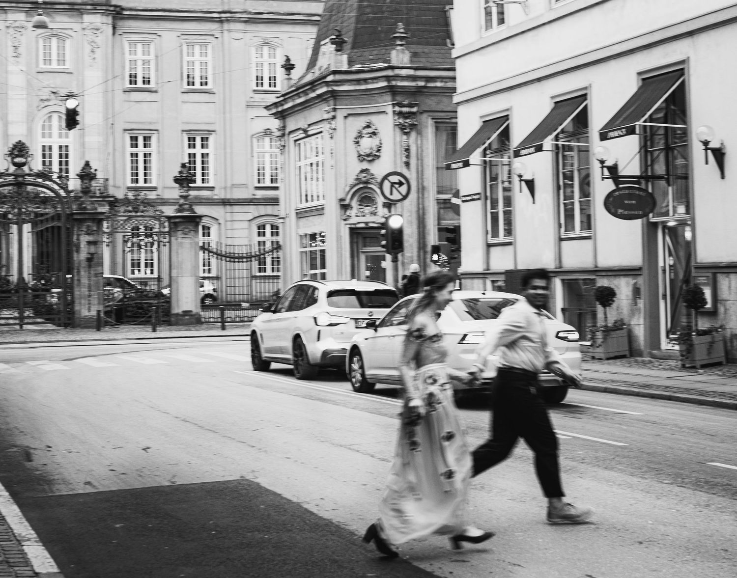 Bride and Groom running across the street in Copenhagen captured by the local photographer Kat Deptula