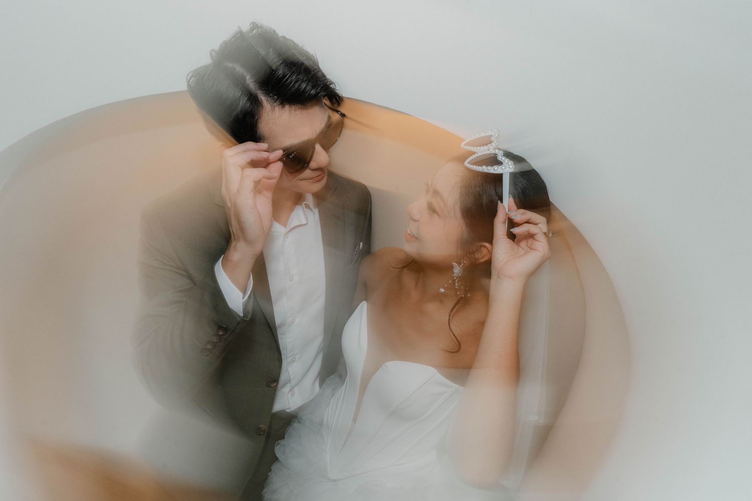 A romantic wedding couple shares an intimate moment in a series of soft, ethereal photographs.