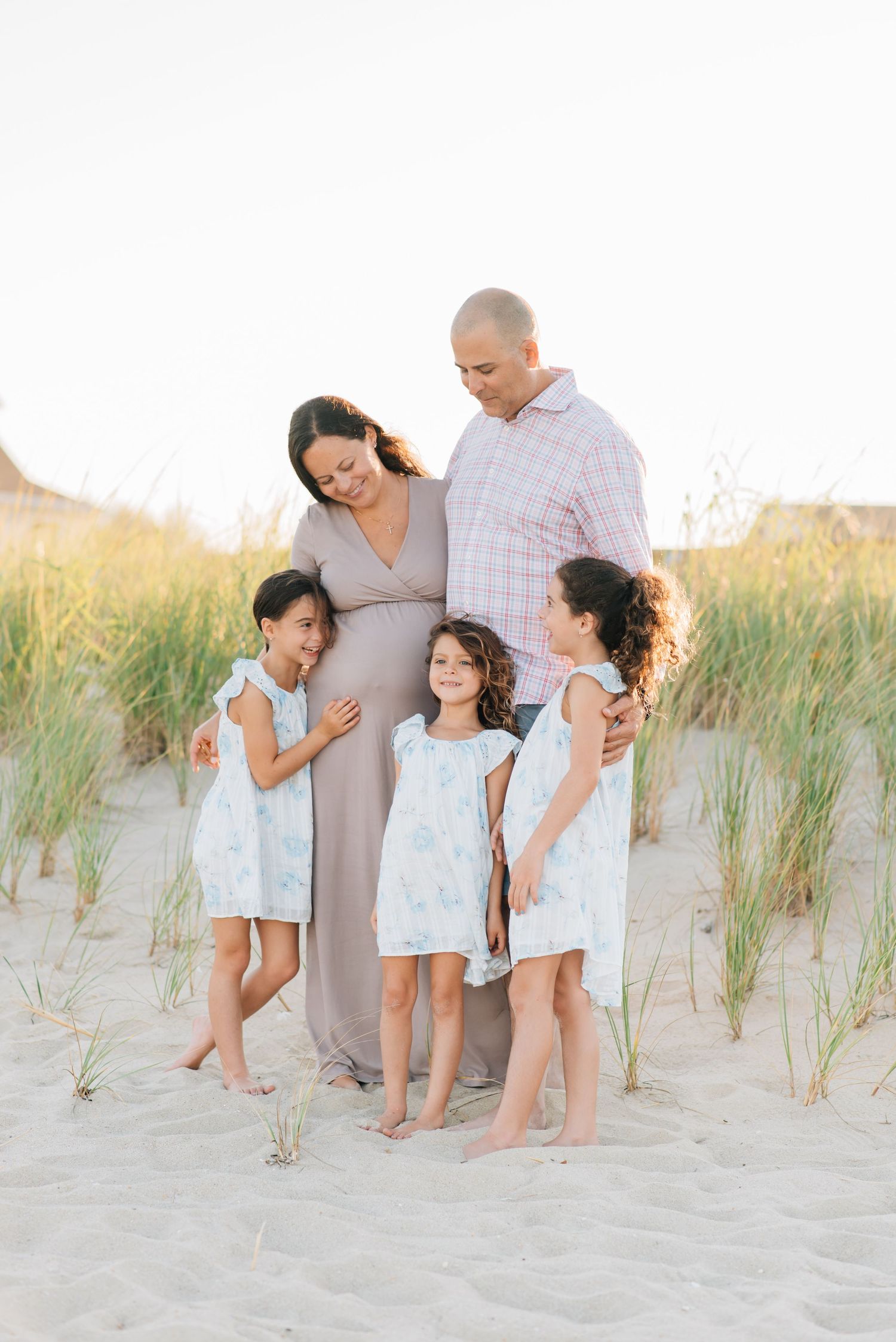 Relaxed Jersey Shore beach family photos in Monmouth Beach NJ with light blue, pink, and white outfits.