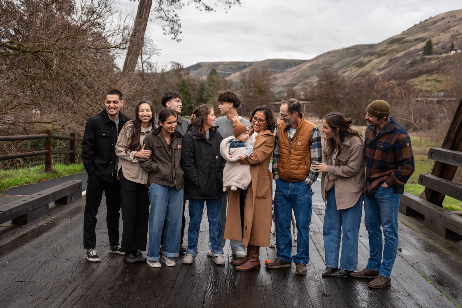 A group of friends in casual attire standing together on a path in an outdoor setting.