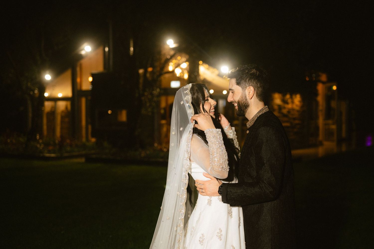 Delicate white veil flows in the breeze during an outdoor wedding ceremony.