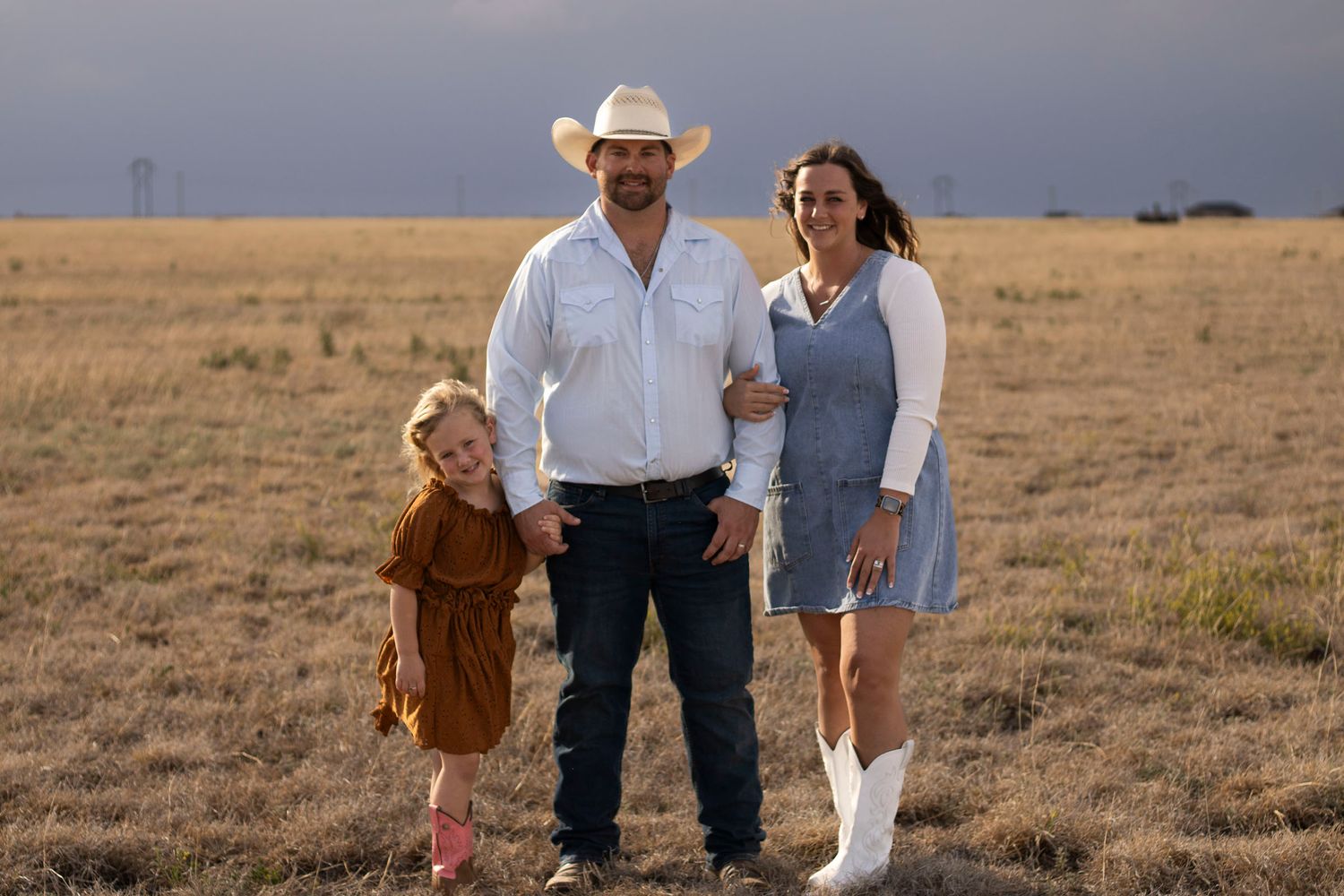 A family of three during a family photo session at The McDonald Ranch in Amarillo, Texas