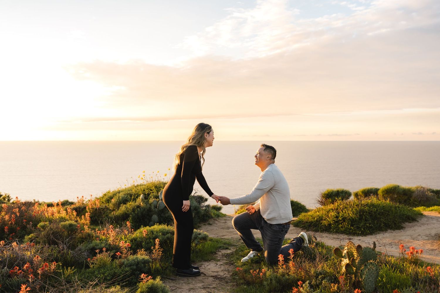Man proposes to girlfriend on the cliffs overlooking the ocean at Glider Point in La Jolla
