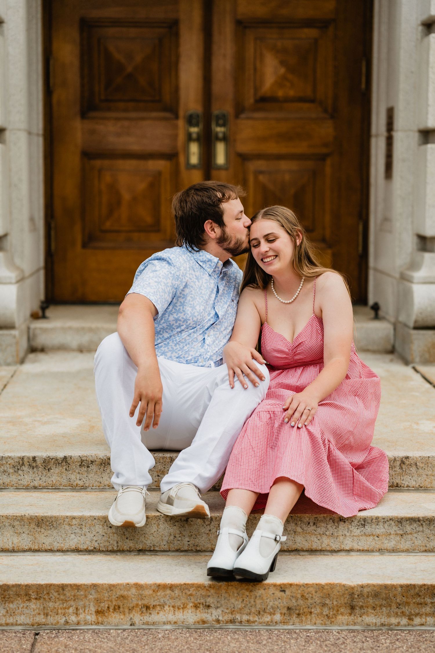 Bailee + Alex hold hands and smile.