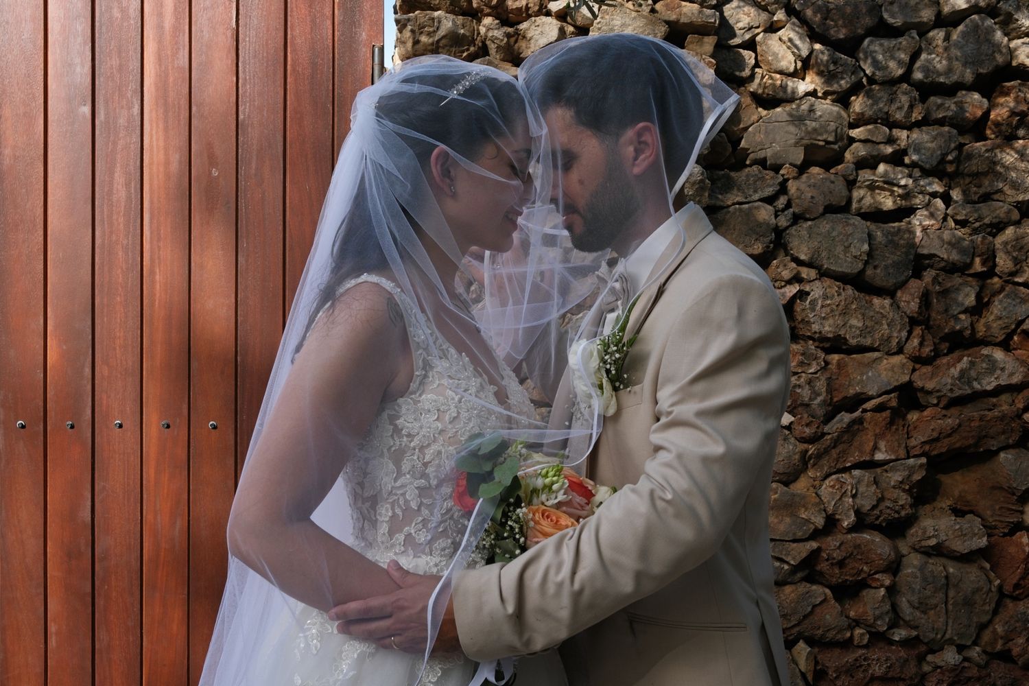 Bride and groom under the veil during their newlyweds photo session at As Fontes Events, Alte, Algarve.