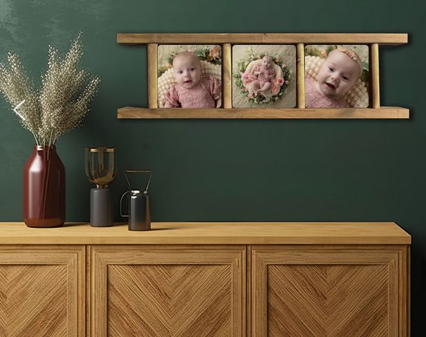 Dark teal wall creates a dramatic backdrop for wooden furniture and framed artwork in a modern living space.