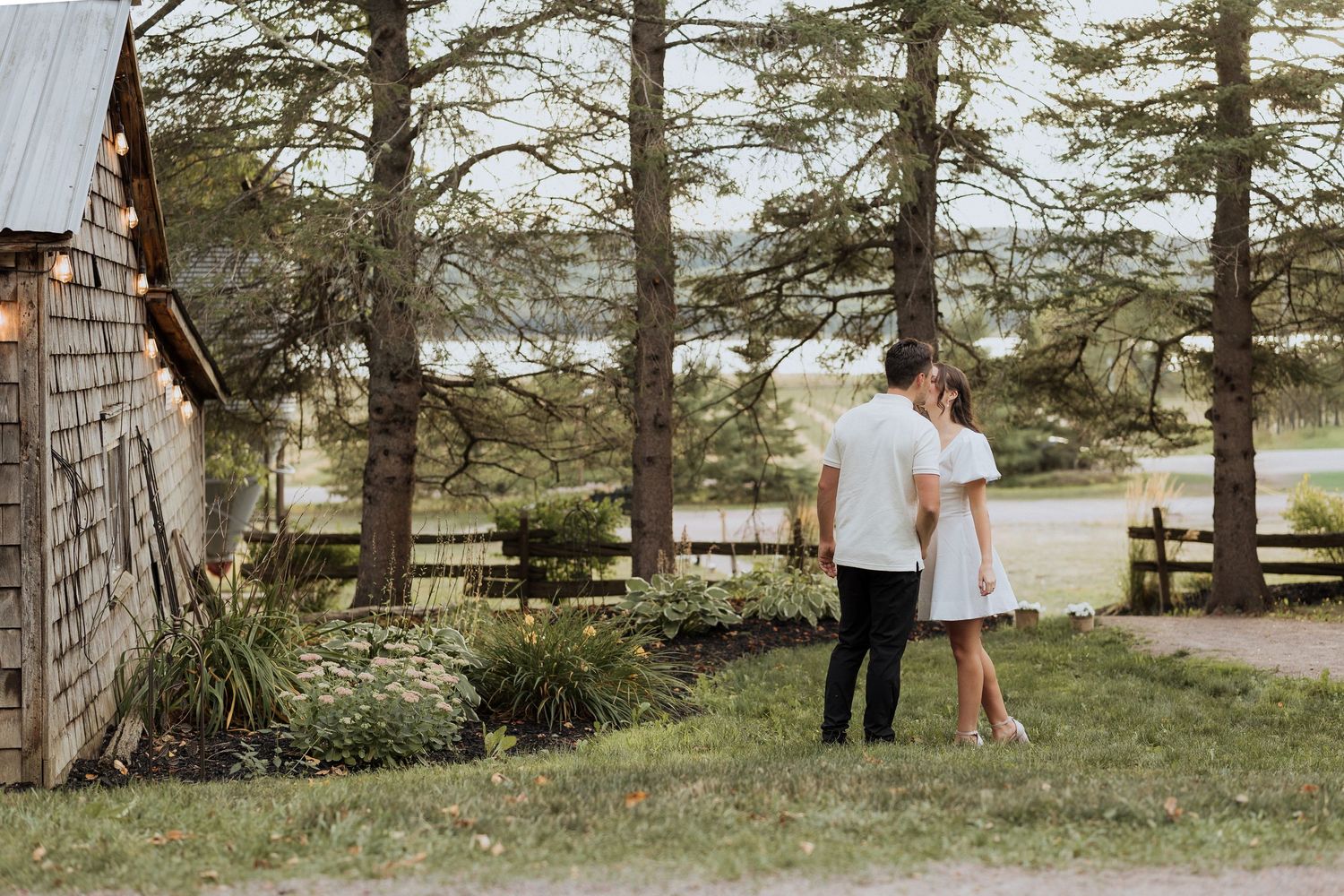 Bride and groom kissing infront of Crooked River Distillery in Memramcook, wedding photography, elopement portraits, surprise wedding