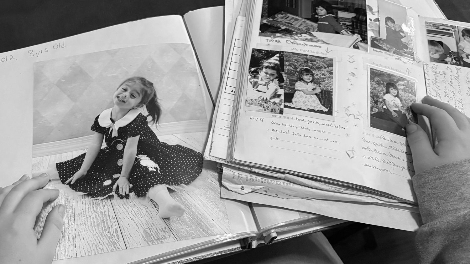 photo album showing vintage black and white photographs and printed pages.
kid photography
child photography
Portrait photography